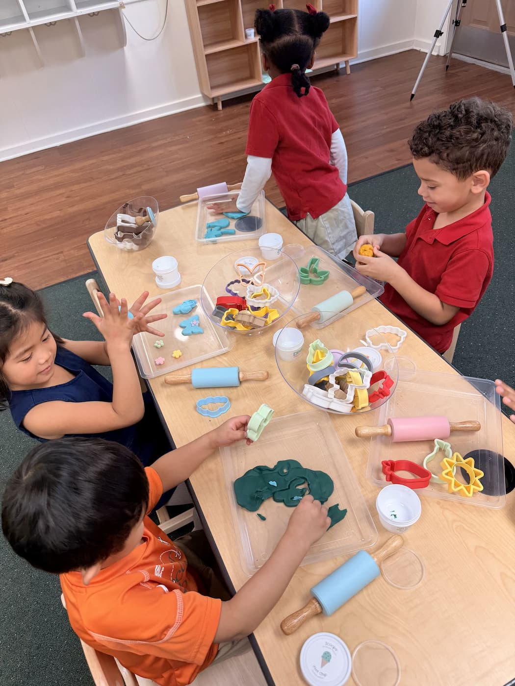 Children shaping playdough with classroom tools in hands-on Palm Grove Montessori activity